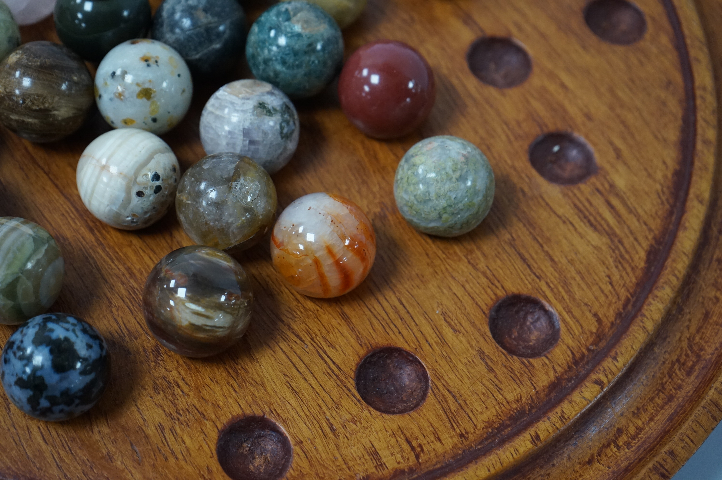 A a large padouk wood solitaire board with hardstone marbles, board 32cm diameter. Condition - good